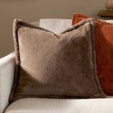 Kallu Plain Faux Fur Cushion in mocha brown, square with flanged edge, styled on a beige sofa beside a rust-orange cushion.