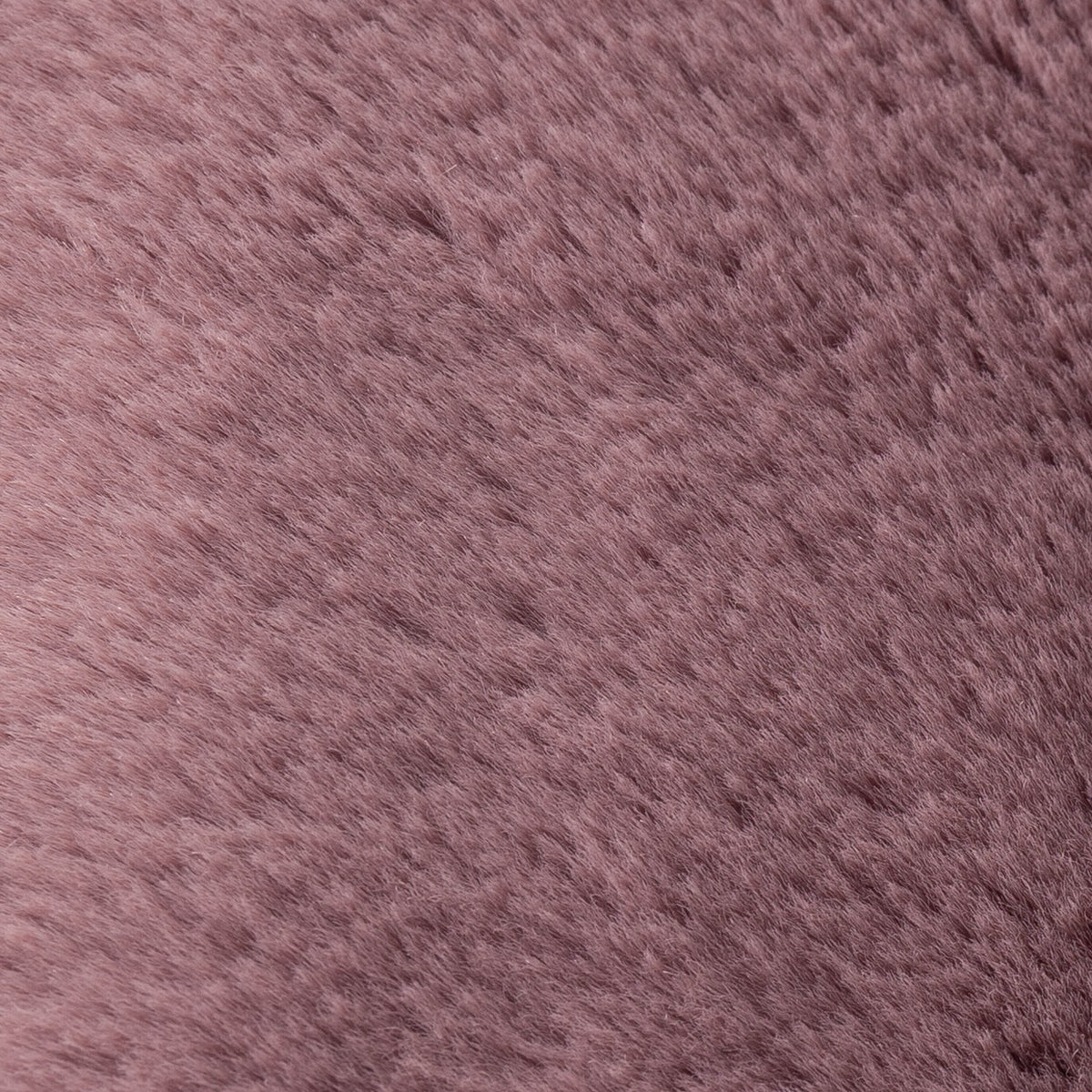 Close-up of the Kallu Reversible Faux Fur Cushion in mulberry, showing the dense, brushed pile in a muted dusky pink polyester finish.