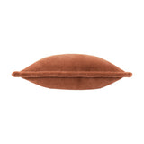 Side view of the Kallu Reversible Faux Fur Cushion in rust, showing its plump, rounded shape and dense plush pile on a plain white background.