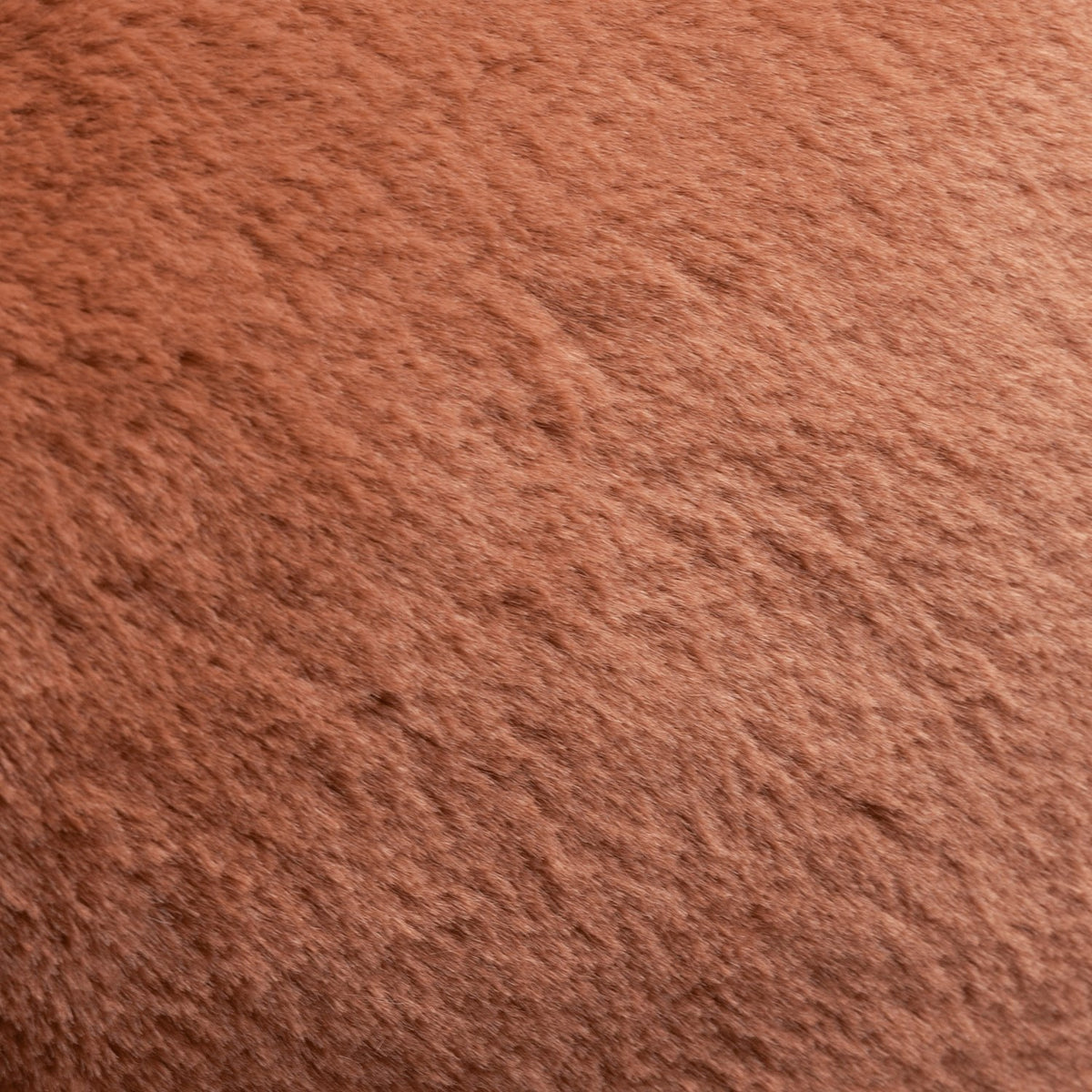 Close-up of the Kallu Reversible Faux Fur Cushion in rust orange, showing the dense, plush pile texture of the fabric.
