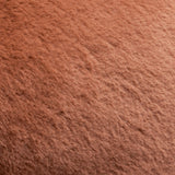 Close-up of the Kallu Reversible Faux Fur Cushion in rust orange, showing the dense, plush pile texture of the fabric.