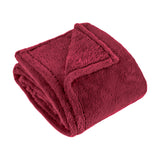 Kallu Polyester Throw in berry-red faux fur, folded to show its dense plush pile and neat edge stitching, on a plain white background.