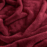 Kallu Polyester Throw in Berry, a deep red faux fur throw with dense, plush pile shown in close-up folds and ripples.