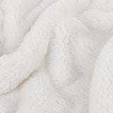 Close-up of the Kallu Reversible Faux Fur Throw in ecru, showing soft, dense pile fabric with gentle folds in a plain neutral tone.