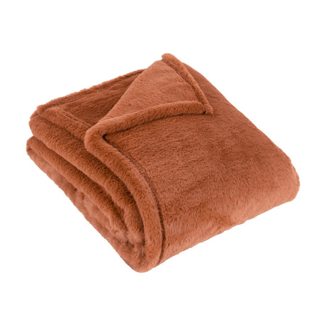 Kallu Reversible Faux Fur Throw in rust, neatly folded showing a dense soft pile with a plain woven border, on a plain white background.