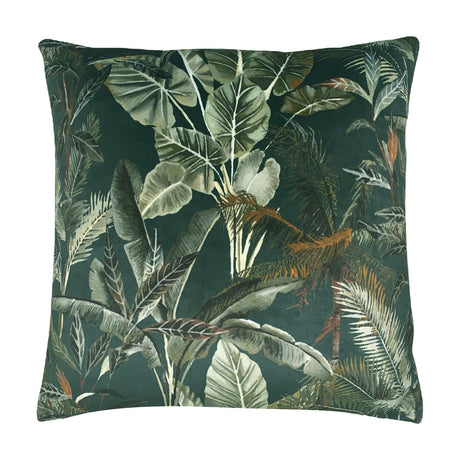 Kibale Jungle square polyester cushion with a dense tropical leaf print in green, sage and rust-brown tones on a deep forest-green ground, shown on a white background.