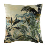Kibale Jungle square polyester cushion, 43 x 43cm, with a printed tropical scene of green leaves and palm fronds over a faded sandy landscape, shown on a white background.