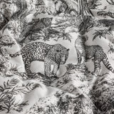 Kisumu Cotton Jungle Duvet Cover in monochrome, close-up of the crumpled cotton fabric showing black and white toile print with leopards and foliage detail.