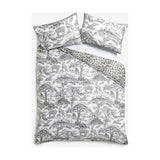 Monochrome cotton duvet cover set with black and white jungle toile pattern of trees, elephants, leopards and monkeys, plus matching pillowcases and reverse leopard print.