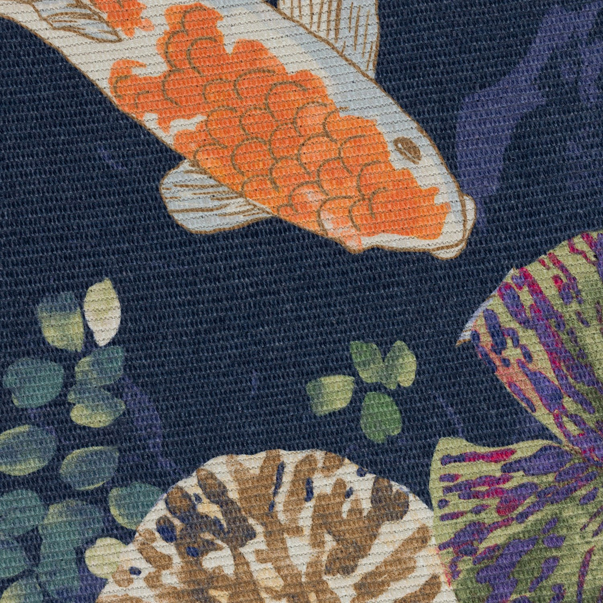 Close-up of the Koi Pond Animal Polyester Rug in Midnight, showing an orange and white koi carp with lily pads printed on a navy blue flatweave surface.