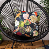Koi Pond Reversible Polyester Cushion in Midnight, square scatter cushion with koi carp and lily pad print on black wicker chair, outdoor lifestyle setting.