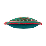 Les Animaux Croc Monsieur cushion shown side-on, teal fabric with tufted crocodile embroidery, pink floral accents, coral fringe trim, and teal velvet reverse, on a white background.