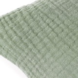 Close-up of the Lark Reversible Cotton Cushion in eucalyptus green, showing the crinkled four-layer muslin cotton texture and subtle woven ribbing.