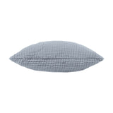 Lark Plain Cotton Cushion in mineral blue, shown side-on to reveal its crinkled muslin cotton texture and plump square shape, set against a plain white background.