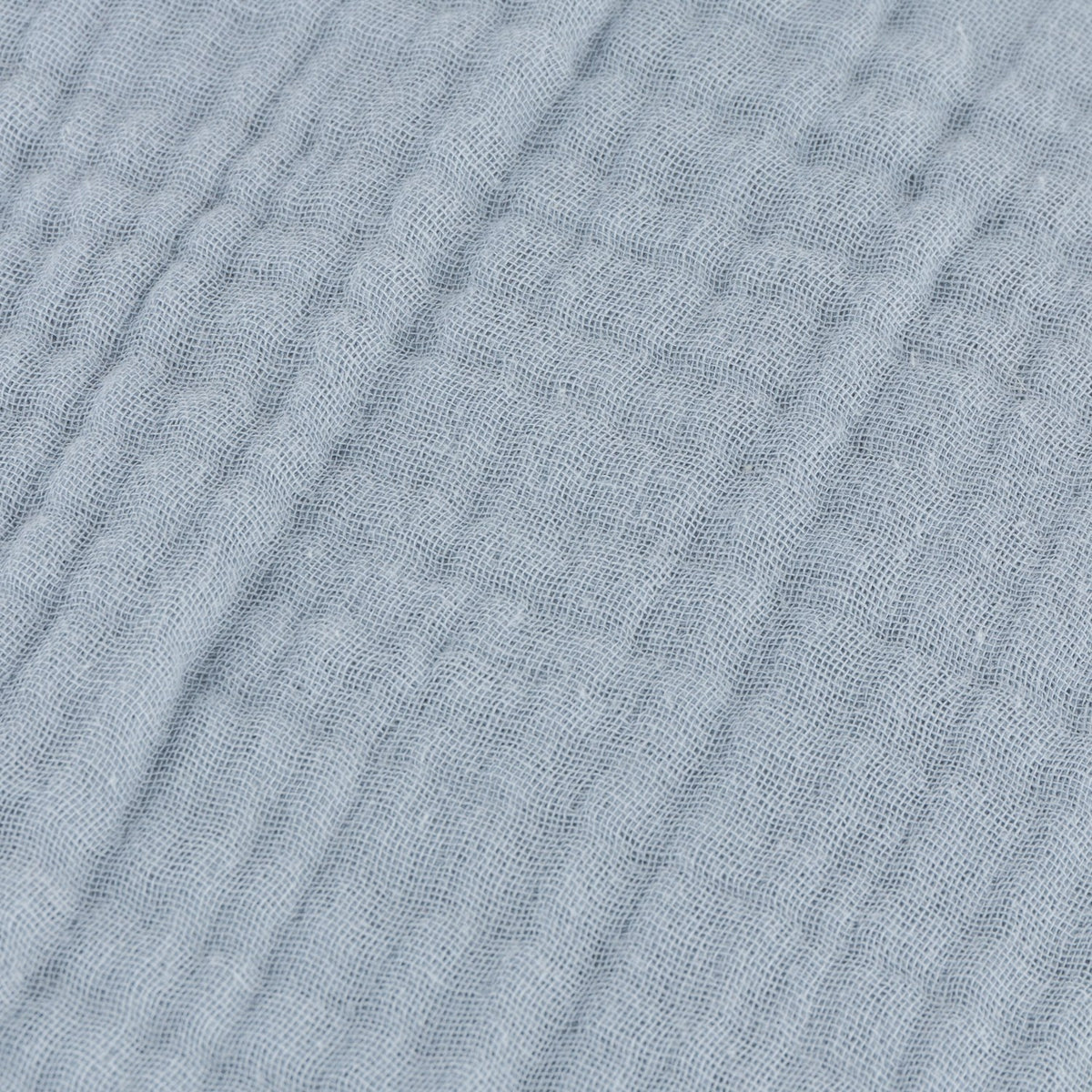 Close-up of the Lark Plain Cotton Cushion in mineral blue, showing crinkled muslin cotton fabric with a fine ribbed, textured weave.