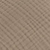 Close-up of the Lark Plain Cotton Cushion in mole brown, showing the crinkled four-layer muslin cotton texture with fine rippled lines.