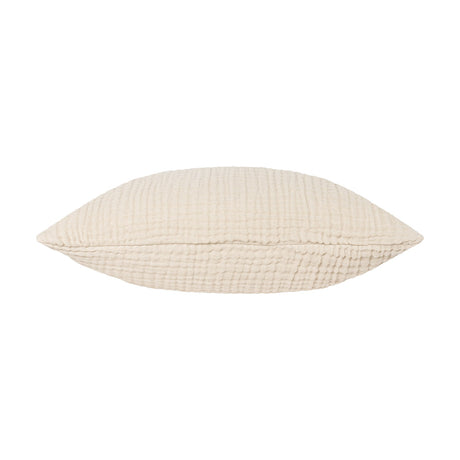Lark Reversible Cotton Cushion in natural beige, shown lengthwise on its side with a crinkled four-layer muslin texture and centre seam, set against a plain white background.