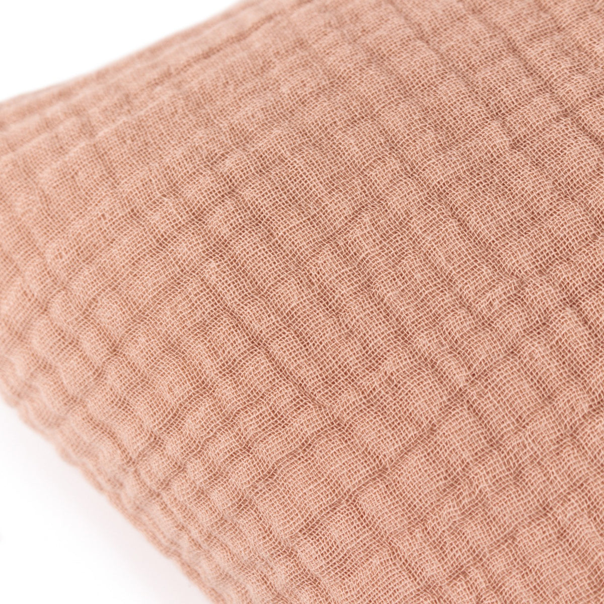 Close-up of the Lark Reversible Cotton Cushion in Pink Clay, showing crinkled four-layer muslin cotton fabric with soft ribbed texture.