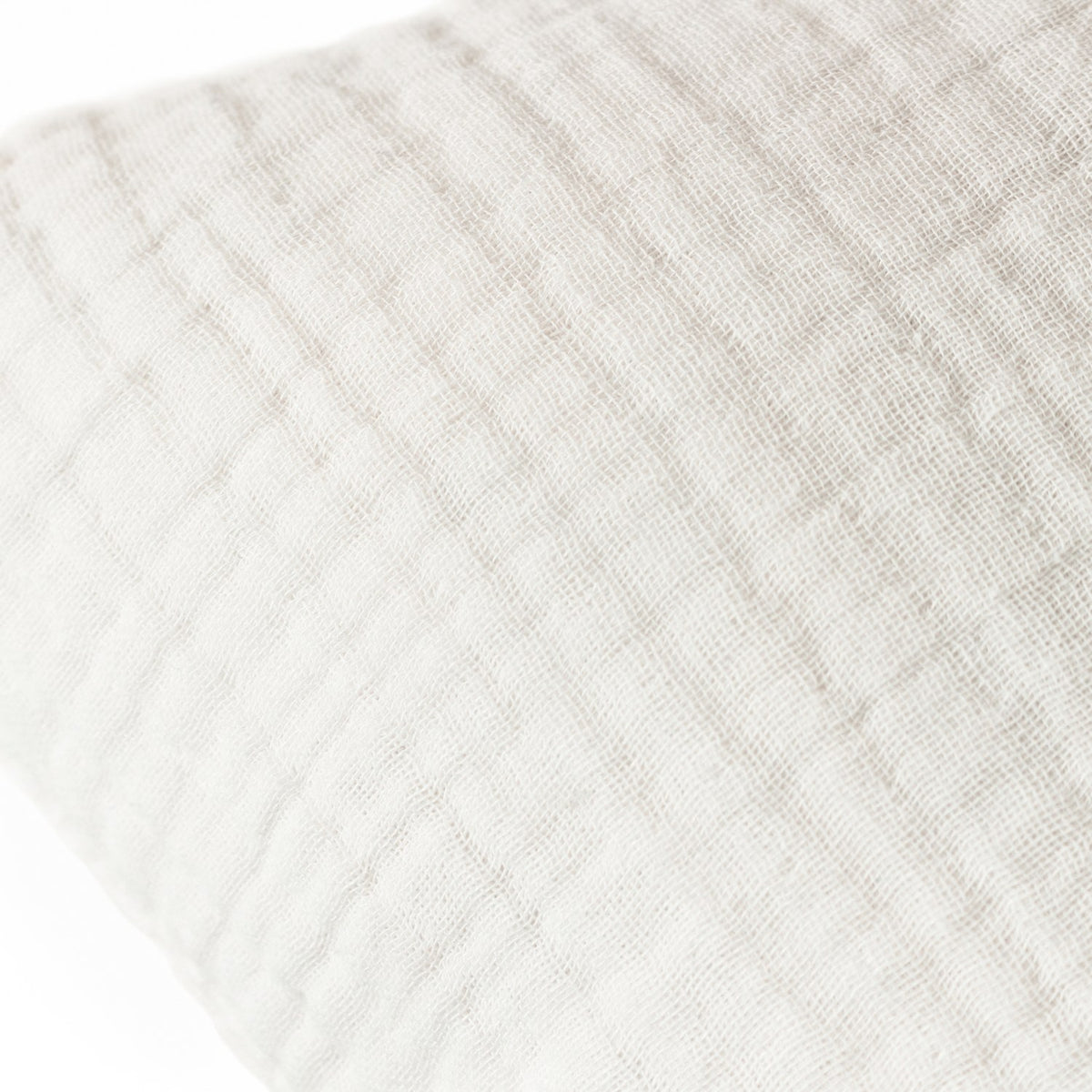 Close-up of the Lark Reversible Cotton Cushion in white, showing the textured, ribbed muslin crinkle cotton surface against a plain white background.