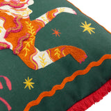 Les Animaux Tigeress cushion in emerald, close-up of embroidered tiger in orange, rust, cream and pink with stars, wavy border and red fringe trim.