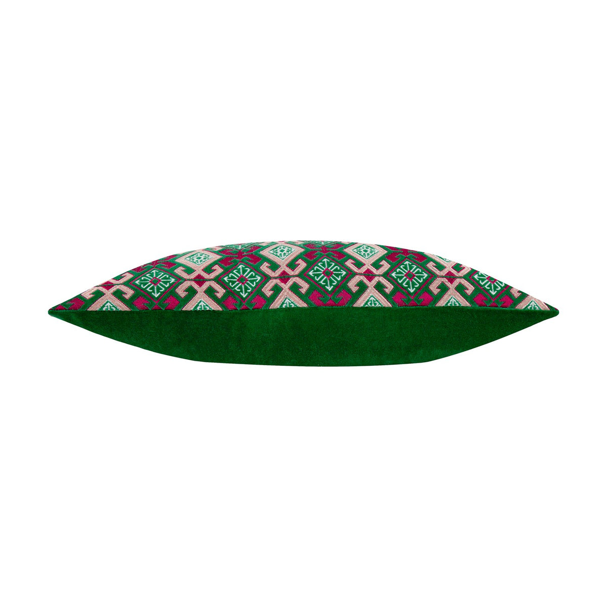 Side view of the Laurel Velvet Cotton Cushion in Cerise/Jade, a bolster cushion with a green velvet back and a folk-inspired geometric pattern in cream, green and cerise on the front.