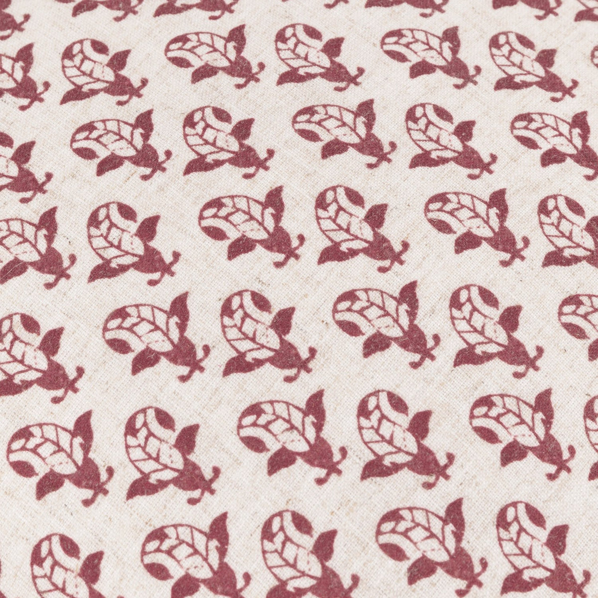 Lulah Block Floral Linen Cushion in red, close-up of repeating leaf-shaped block-print motif on natural linen-blend fabric.