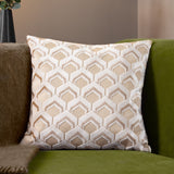 Ledbury Jacquard Velvet Cushion in Warm Taupe with raised hexagonal pattern, shown on a green sofa in a living room setting.