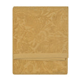 Folded Leicester cotton towel in gold with a sculptured floral and foliage pattern, woven border, shown against a plain white background.