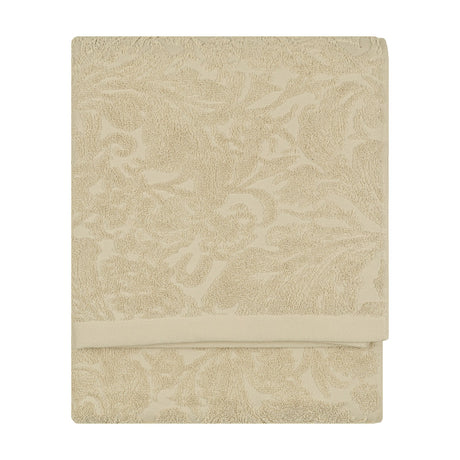 Leicester Floral Cotton Towel in natural, folded flat with a raised scrolling leaf and floral pattern woven into the pile, shown against a plain white background.