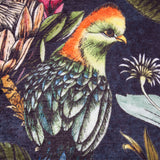 Leilani Velvet Chenille Cushion in Twilight, close-up of chenille fabric showing a bird with orange crest and green plumage among tropical flowers and leaves on a deep midnight ground.
