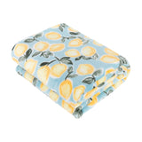 Folded polyester throw in blue with a repeated lemon print featuring yellow lemons and grey-green leaves, shown on a plain white background.