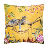 Square gold polyester cushion featuring a hand-painted leopard resting on a branch amid tropical foliage, orchids, peonies and hummingbirds, shown on a white background.