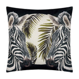Square polyester cushion in black featuring two mirrored zebra heads with olive and cream palm fronds, part of the Leopardis reversible design.
