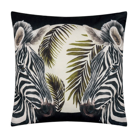 Square polyester cushion in black featuring two mirrored zebra heads with olive and cream palm fronds, part of the Leopardis reversible design.