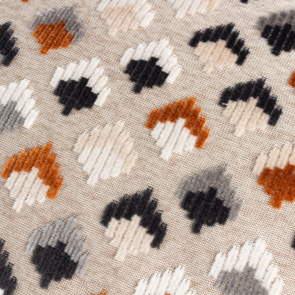 Lexington Jacquard Velvet Cushion in Ginger/Grey, close-up of the raised diamond pattern in rust, charcoal, grey and cream velvet pile on a natural woven ground.