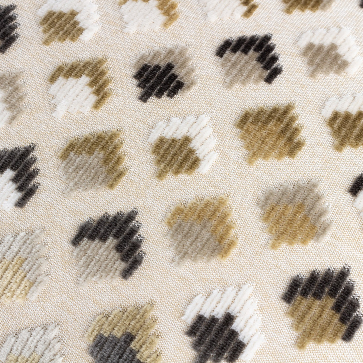 Close-up of the Lexington jacquard velvet cushion in warm taupe, showing raised diamond-shaped motifs in taupe, gold, charcoal, grey and white on a woven fabric base.