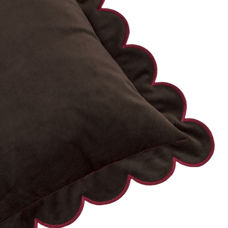 Close-up of the Lil Scallop Plain Velvet Cushion in chocolate brown, showing its scalloped edge with contrast burgundy piping and thread against a white background.