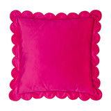 Square pink velvet cushion with a scalloped edge trimmed in contrasting red thread, plain colour block design, shown on a white background.