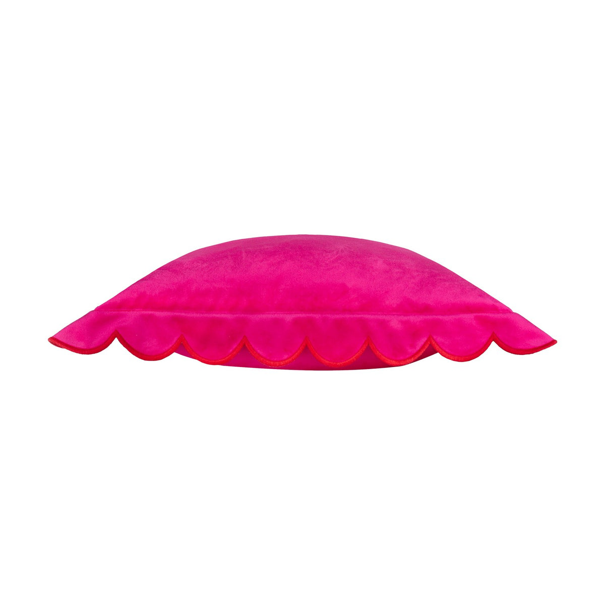Side view of the Lil Scallop Plain Velvet Cushion in pink, showing its scalloped edge trimmed in contrasting red thread, on a plain white background.
