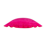 Side view of the Lil Scallop Plain Velvet Cushion in pink, showing its scalloped edge trimmed in contrasting red thread, on a plain white background.