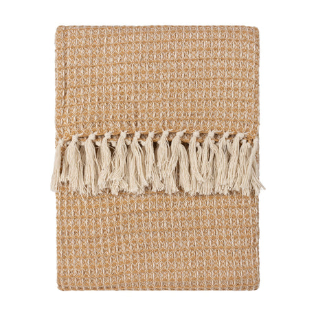 Lorne Plain Cotton Throw in honey, folded flat with a chunky waffle-weave texture and cream tassel fringe, shown on a plain white background.