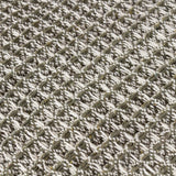 Close-up of the Lorne Plain Cotton Throw in Lichen, showing a chunky two-tone cotton waffle weave in muted green and white creating a textured, heathered surface.