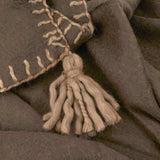 Close-up of the Lowen wool blend throw in chocolate brown, showing whipstitch edge detailing and a hand-tied tassel corner.