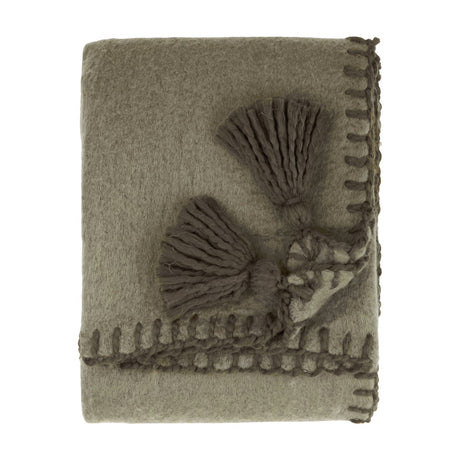 Folded Lowen wool blend throw in moss green with a brushed finish, whip-stitched edges, and decorative tassel detail, shown on a plain white background.