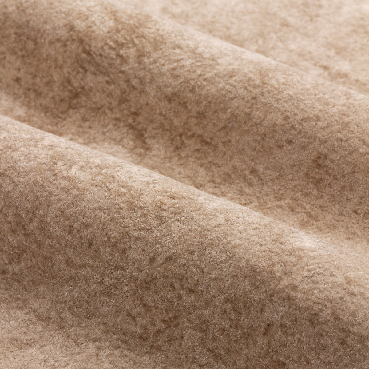 Close-up of Lustre Velvet Plain Fully Lined Eyelet Curtains in oyster, showing the dense, soft-pile velvet fabric with folds highlighting subtle tonal variation.
