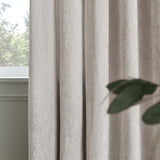 Lustre Velvet Plain Fully Lined Eyelet Curtains in silver, shown in soft folds by a window, with a woven velvet texture and low sheen finish.