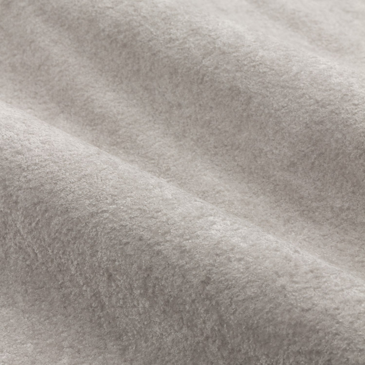 Close-up of Lustre Velvet Plain Fully Lined Eyelet Curtains in silver, showing the soft-pile fabric texture with subtle sheen and gentle folds.