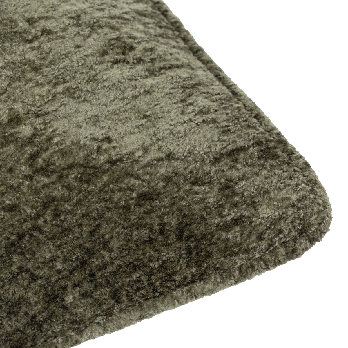 Close-up of the Lustre Velvet Plain Polyester Cushion in Malachite Green, showing the crushed-velvet texture and self-piped edge against a white background.