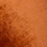 Close-up of the Luxe Velvet cushion in rust, showing the plain polyester velvet pile with a soft sheen and subtle diagonal weave texture.