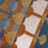 Close-up of the Metro Abstract Jacquard Velvet Cushion in Ginger, showing rust, ochre, teal and blue drop and dot shapes on a cream velvet ground.